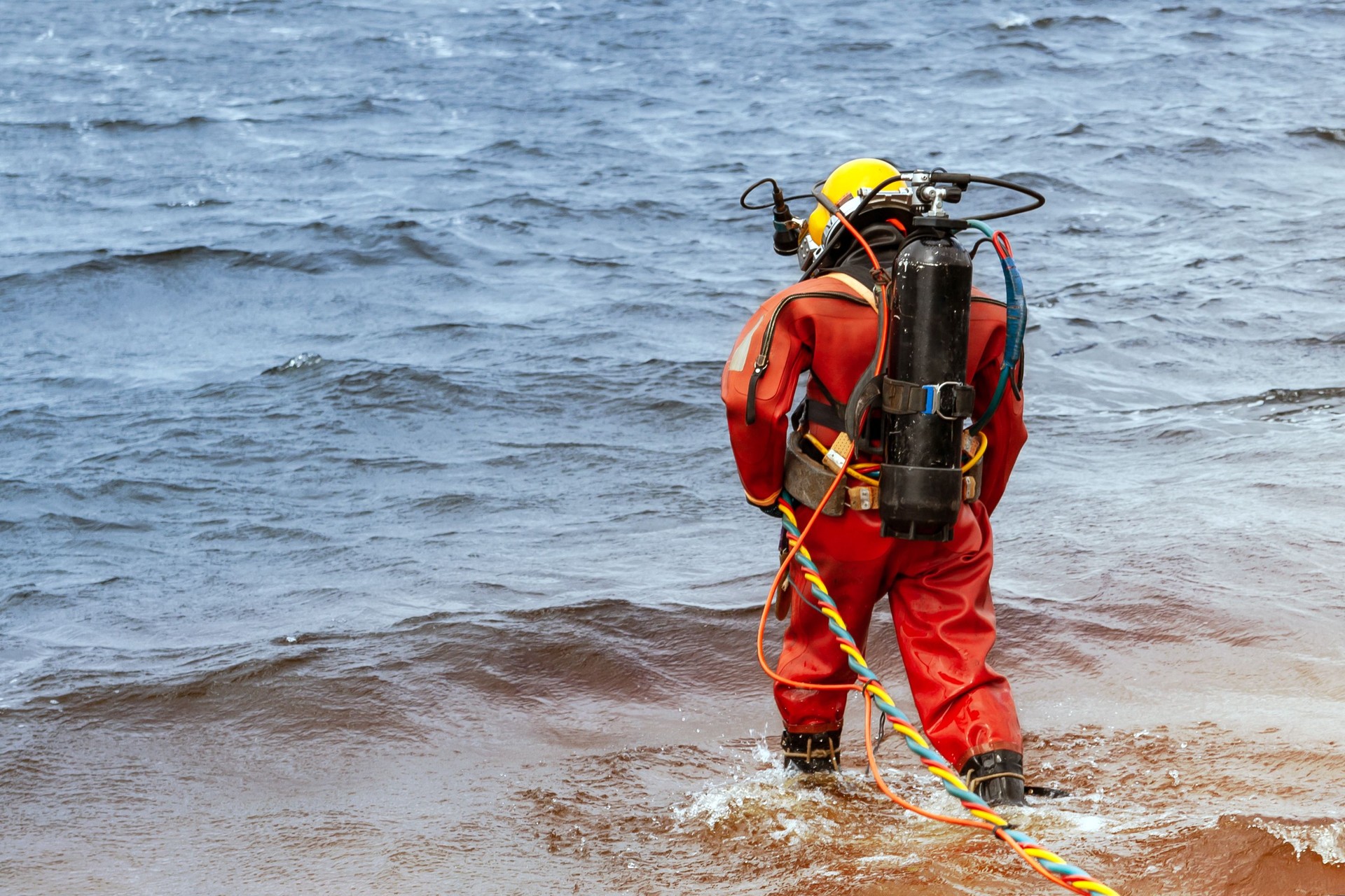 Professional diver enters the water to produce deep-sea works.